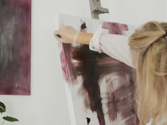 Painting at the easel in the Roberta Heslop Art studio